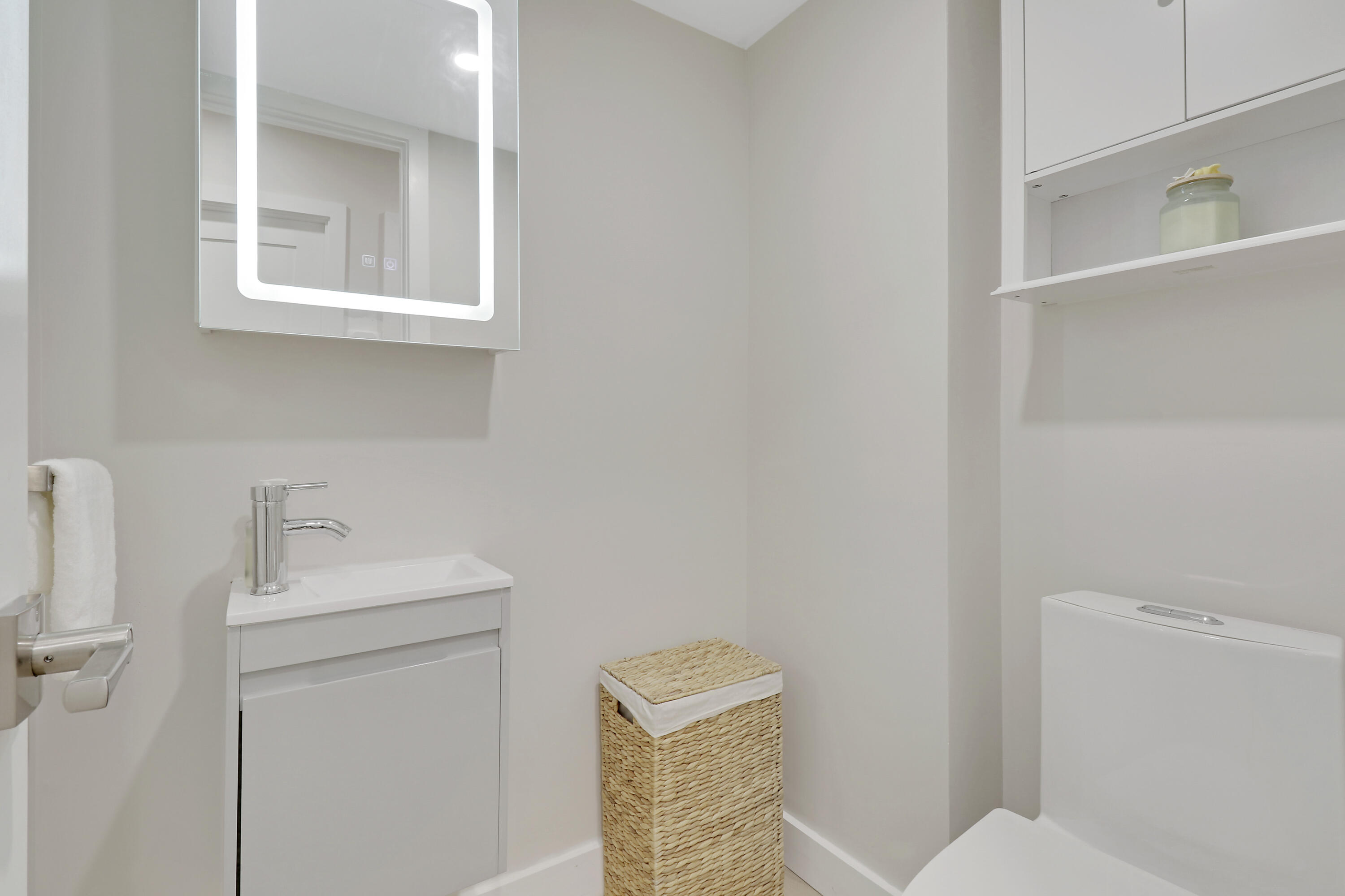 3540 South Ocean Boulevard, Unit 715 South Palm Beach, FL 33480 - Photo 18 of 39 a bathroom with a sink a toilet and a mirror