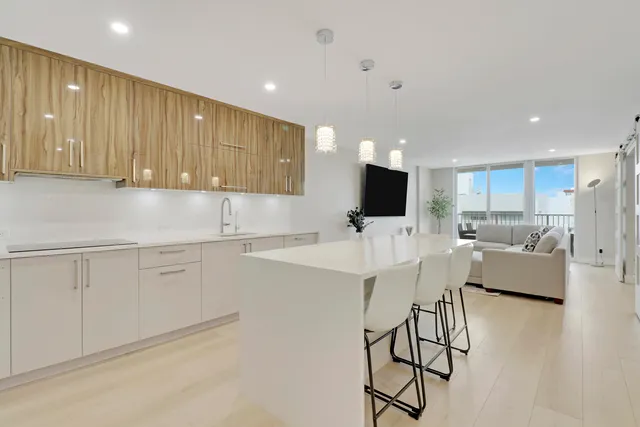 a kitchen with stainless steel appliances kitchen island granite countertop a sink and cabinets