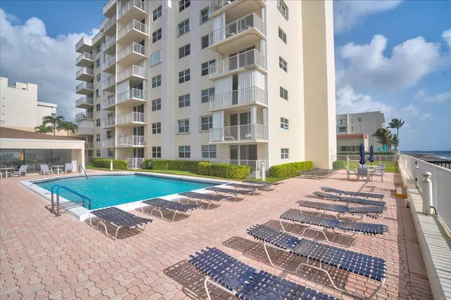 a view of a swimming pool with a yard