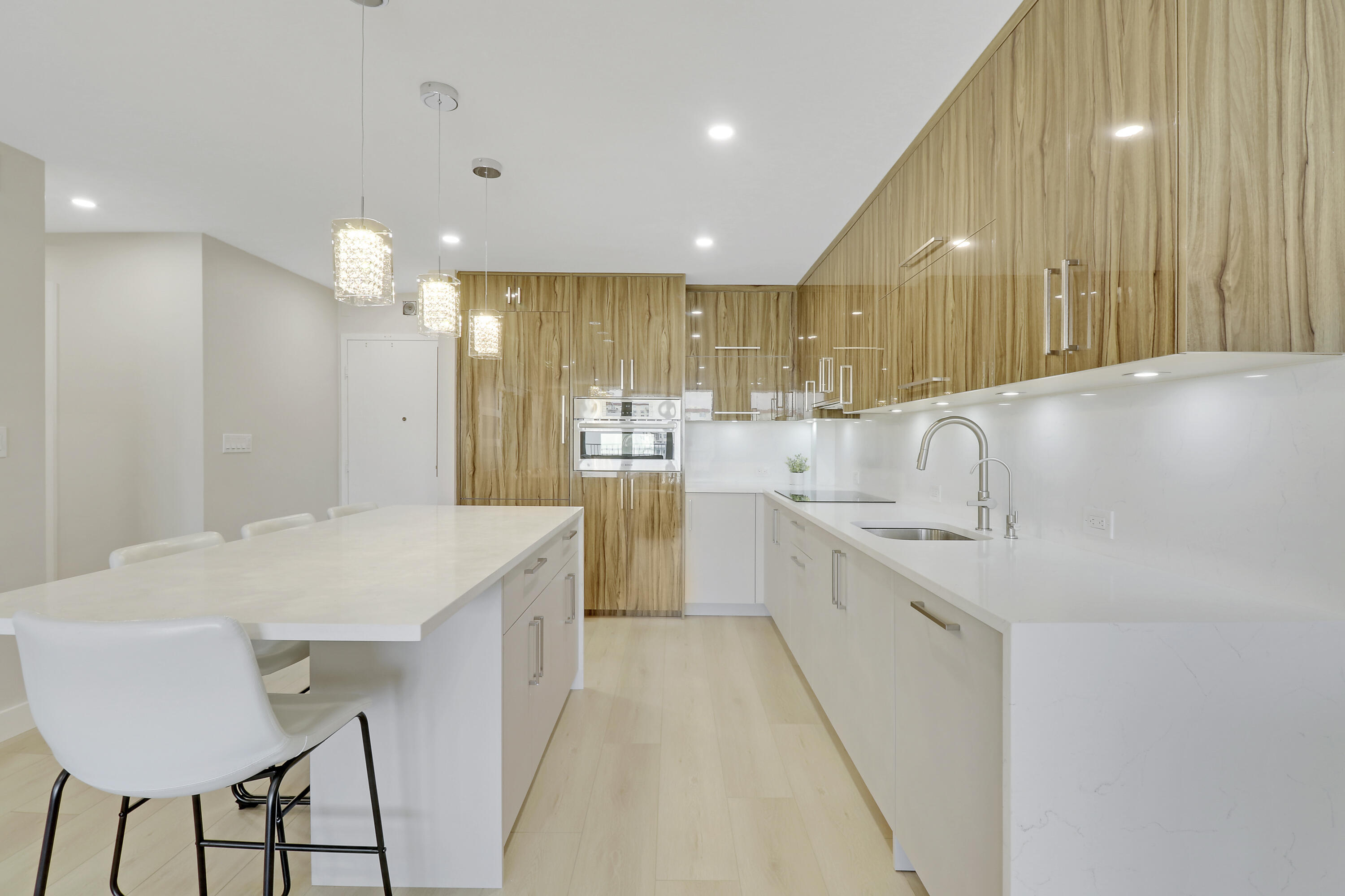 3540 South Ocean Boulevard, Unit 715 South Palm Beach, FL 33480 - Photo 4 of 39 a large kitchen with kitchen island a sink stainless steel appliances and cabinets