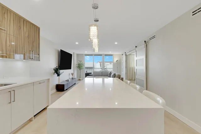 a view of a kitchen with a sink and a refrigerator