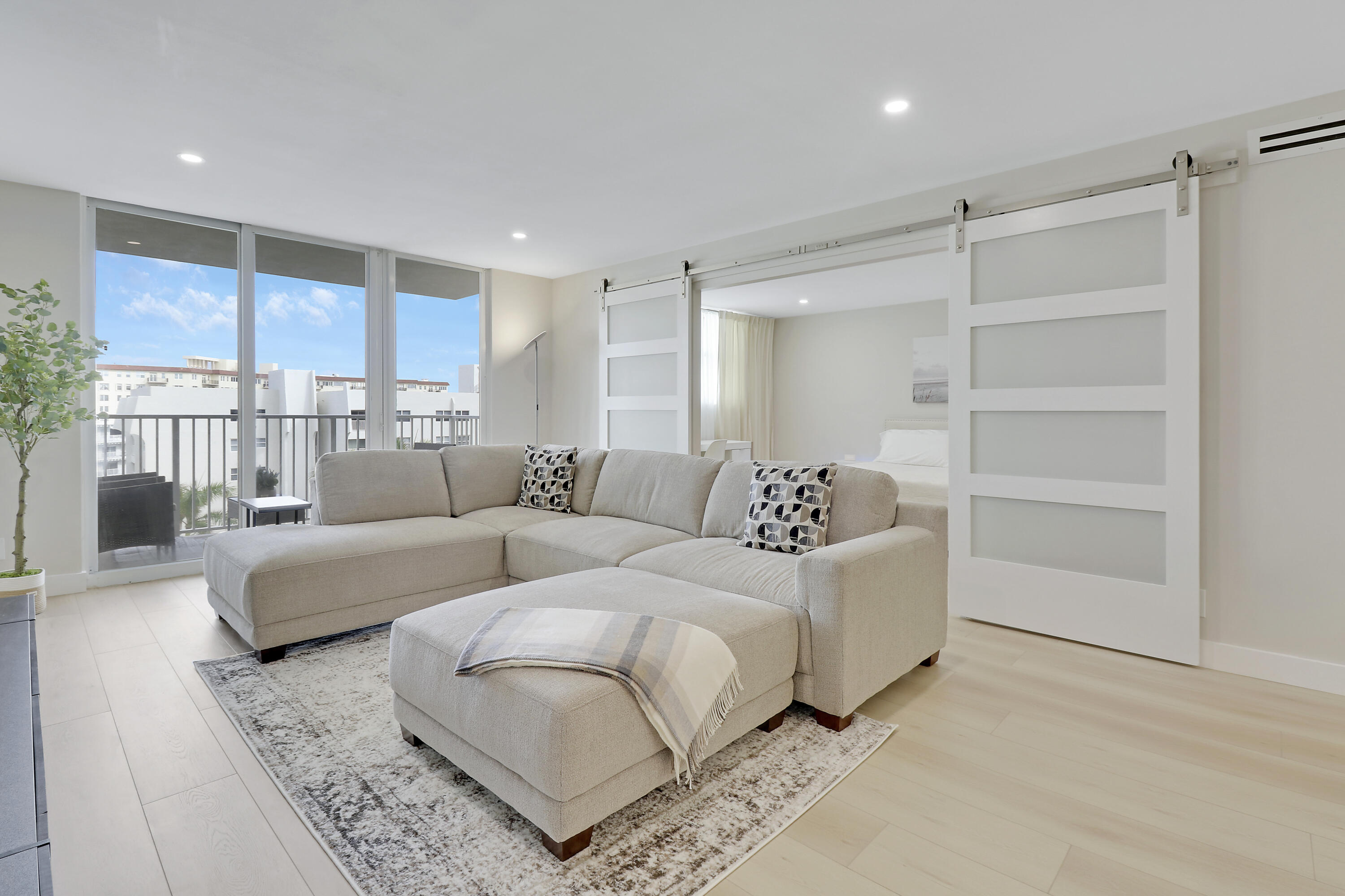 3540 South Ocean Boulevard, Unit 715 South Palm Beach, FL 33480 - Photo 9 of 39 a living room with furniture and a large window
