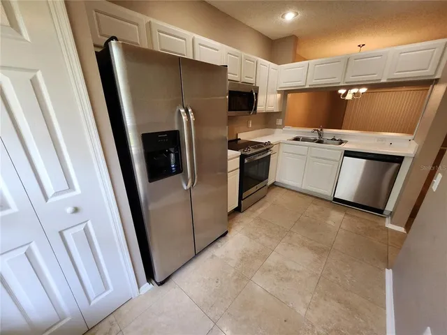 a kitchen with a refrigerator sink and microwave