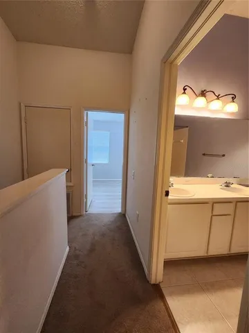 a view of a bathroom with a sink and a mirror