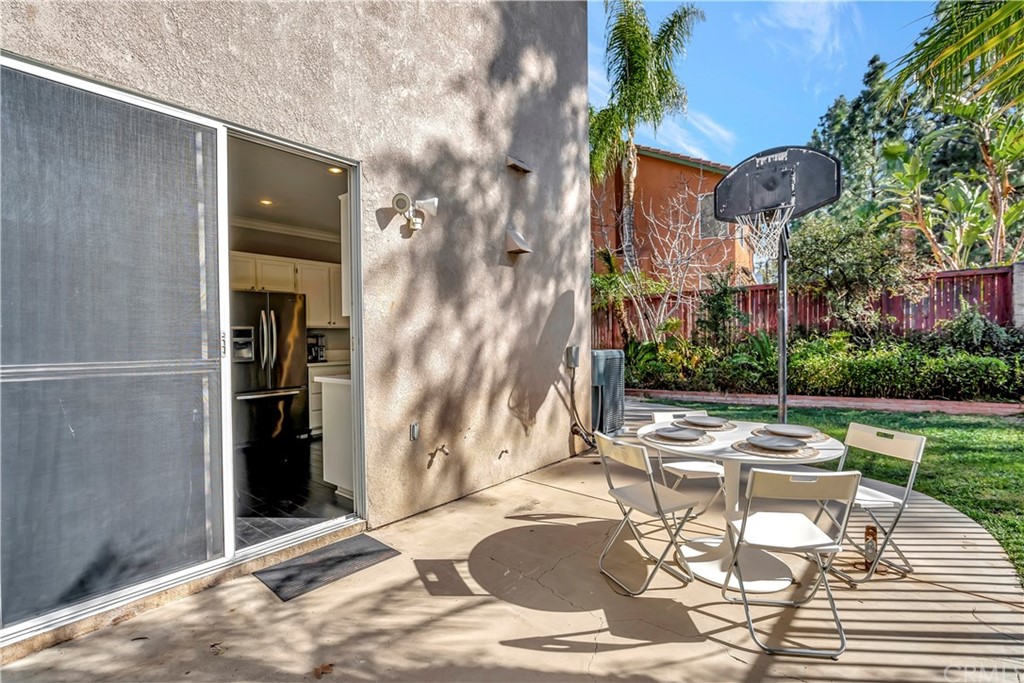 350 Exeter Way Corona, CA 92882 - Photo 22 of 55 a patio with a table and chairs and potted plants