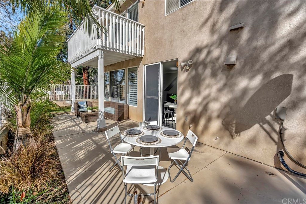 350 Exeter Way Corona, CA 92882 - Photo 23 of 55 a view of a patio with table and chairs and potted plants