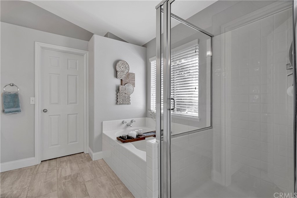 350 Exeter Way Corona, CA 92882 - Photo 34 of 55 a bathroom with a bathtub and a shower