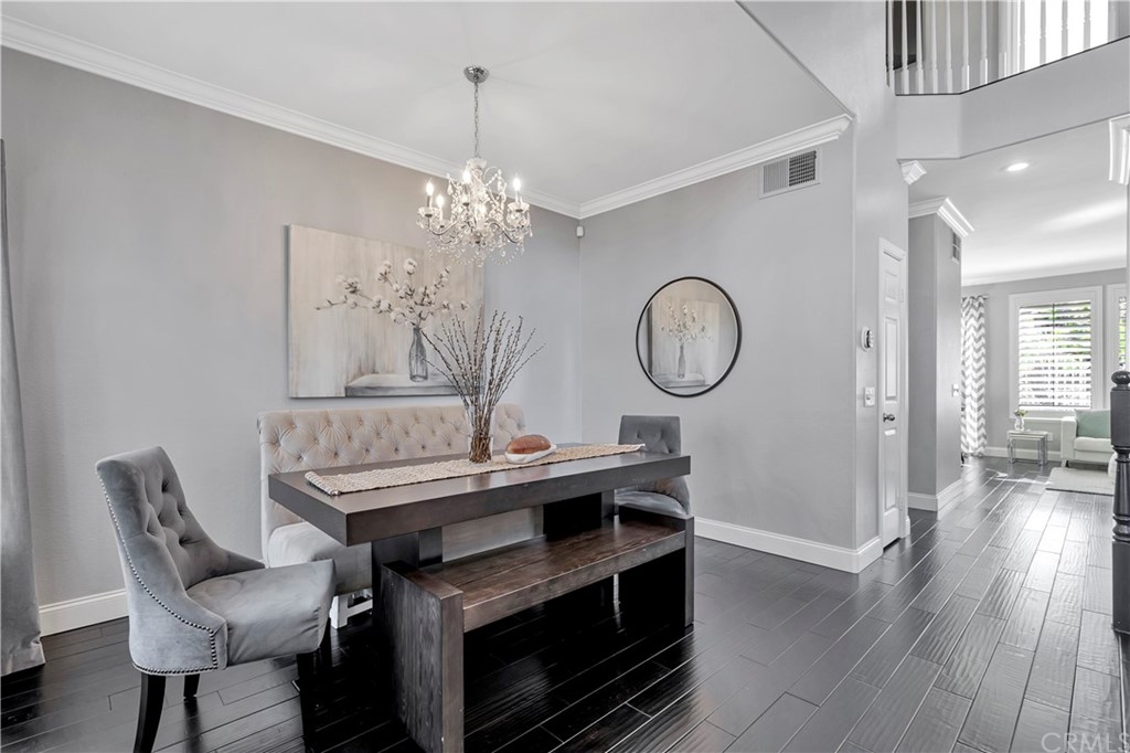 350 Exeter Way Corona, CA 92882 - Photo 6 of 55 a view of a dining room with furniture a chandelier and wooden floor