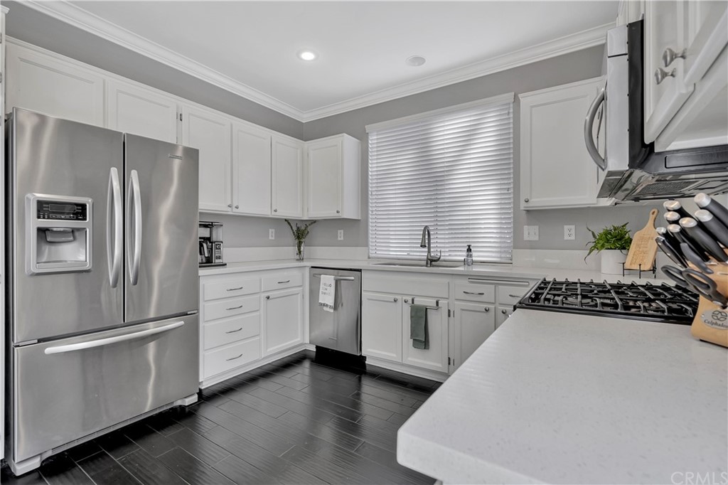 350 Exeter Way Corona, CA 92882 - Photo 10 of 55 a kitchen with white cabinets and white appliances
