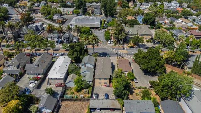 an aerial view of multiple houses with yard