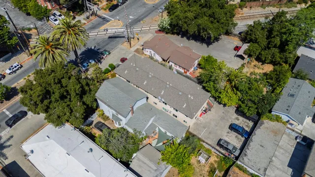 an aerial view of a house with garden space and street view