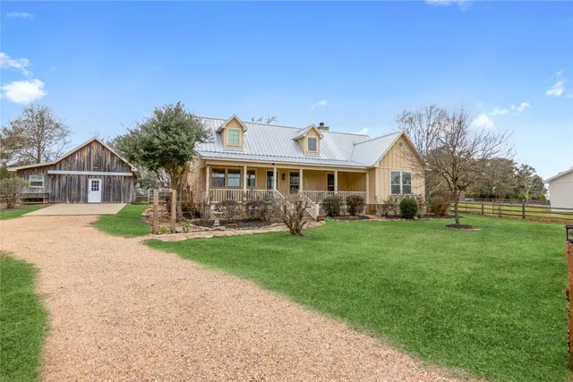 a living room with fireplace furniture and a large window