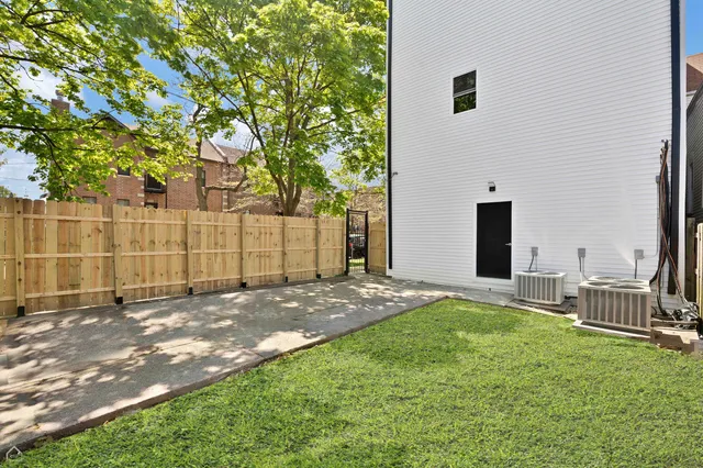 a view of a backyard with a tree