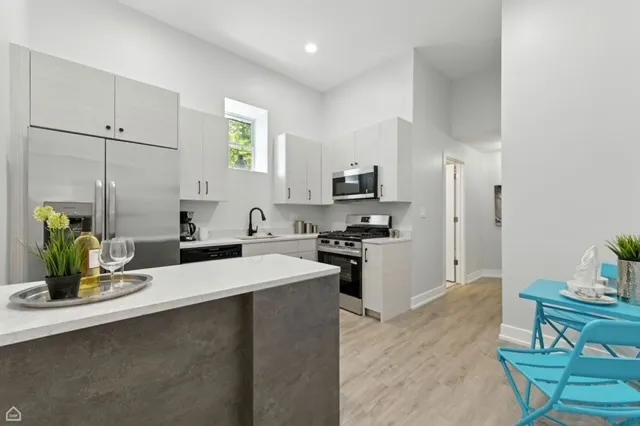 a kitchen with a sink appliances and cabinets