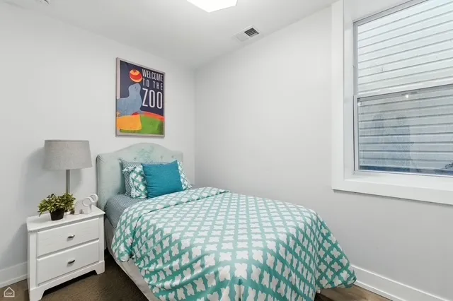 a bedroom with a bed and dresser