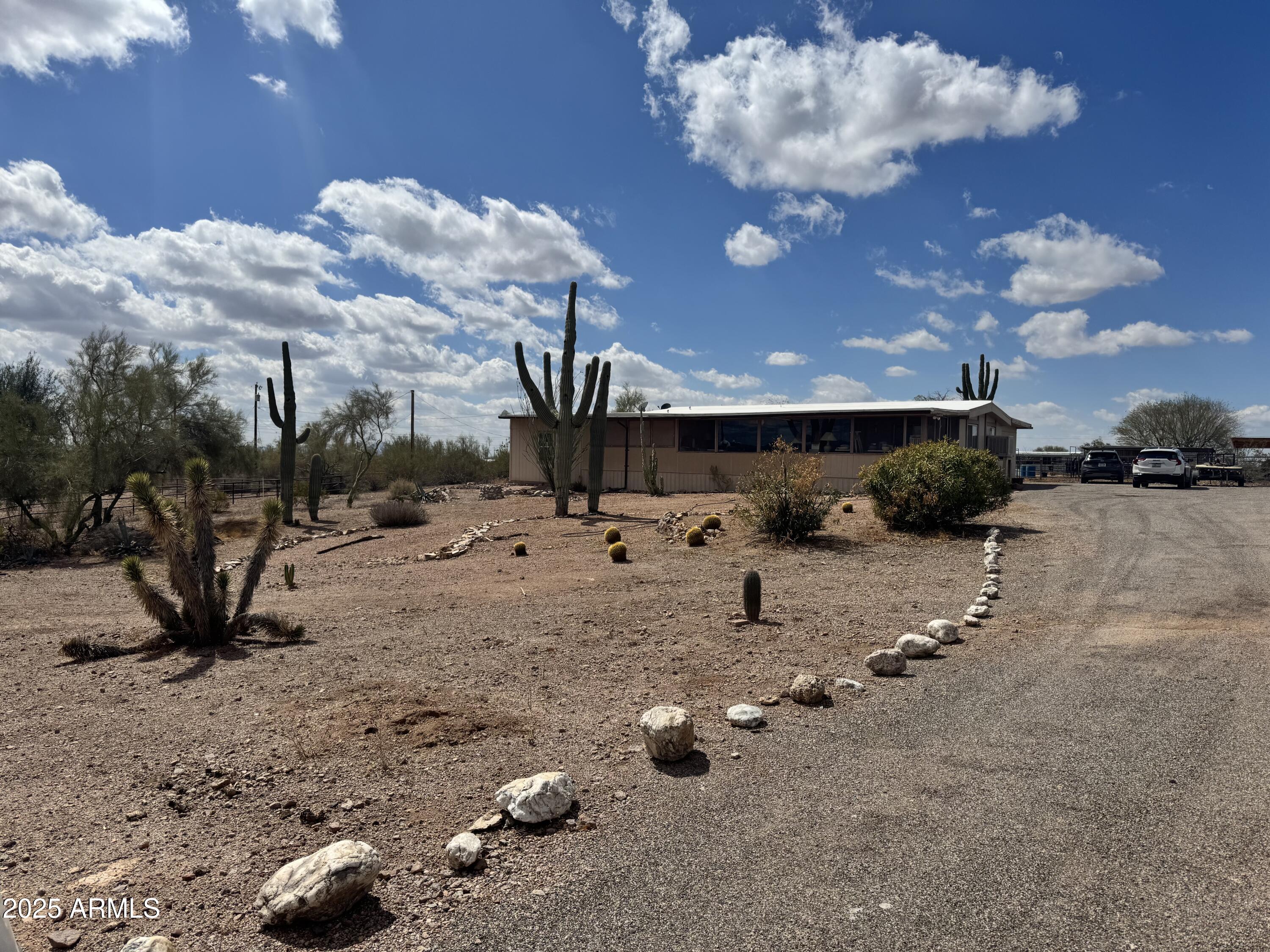 1888 South Goldfield Road Apache Junction, AZ 85119 - Photo 1 of 27 a view of a dry yard with lots of trees