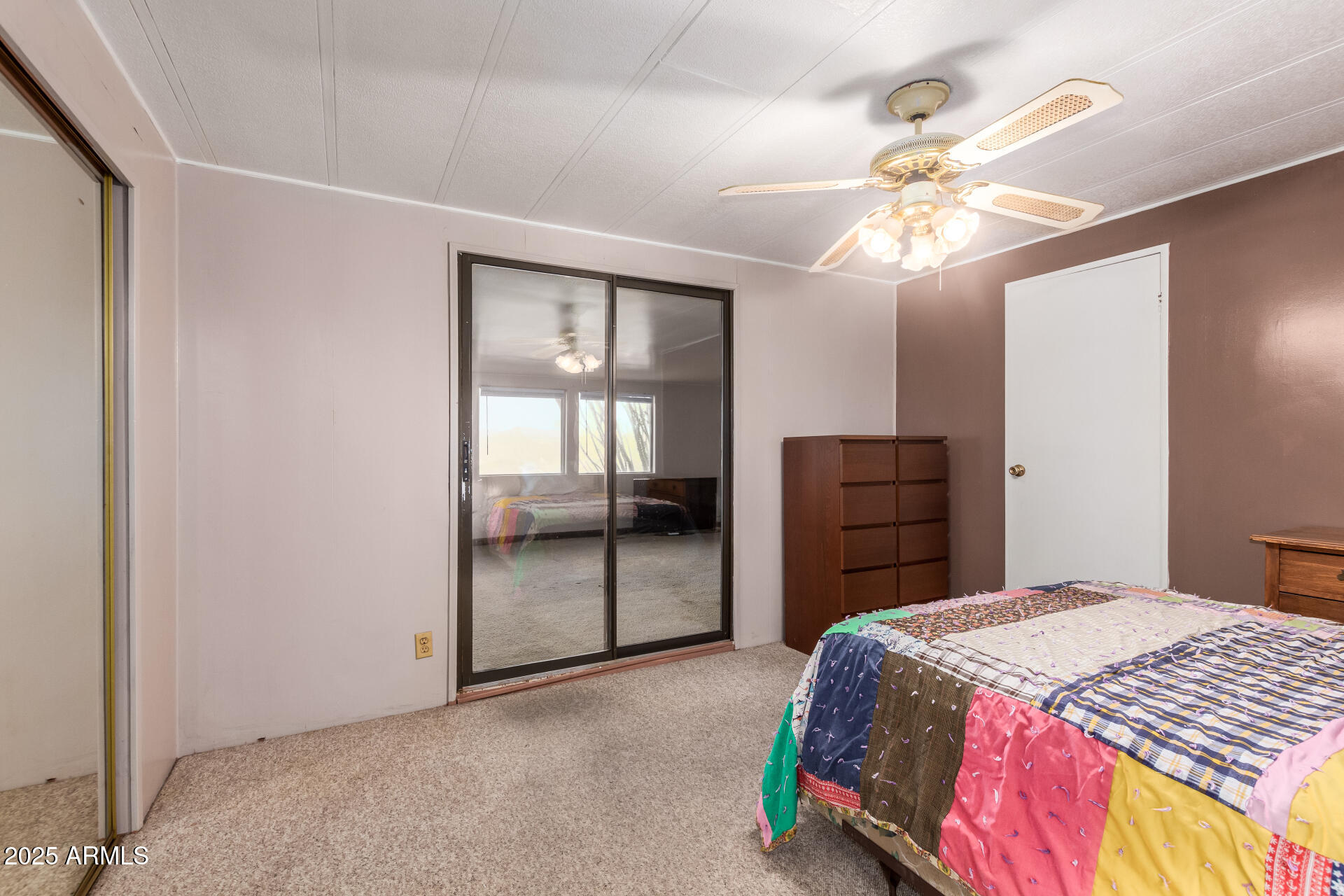 1888 South Goldfield Road Apache Junction, AZ 85119 - Photo 11 of 27 a bedroom with a bed and a chandelier