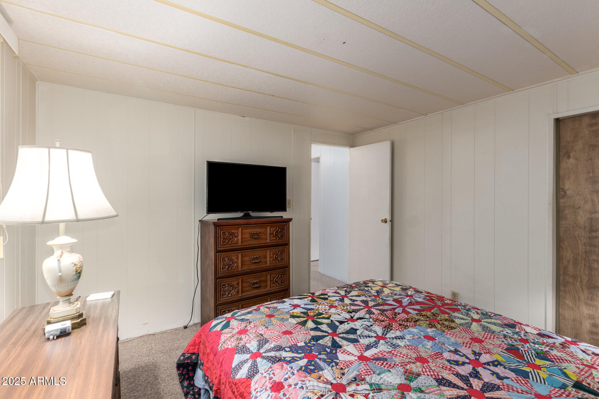 1888 South Goldfield Road Apache Junction, AZ 85119 - Photo 15 of 27 a bedroom with a bed and a flat screen tv