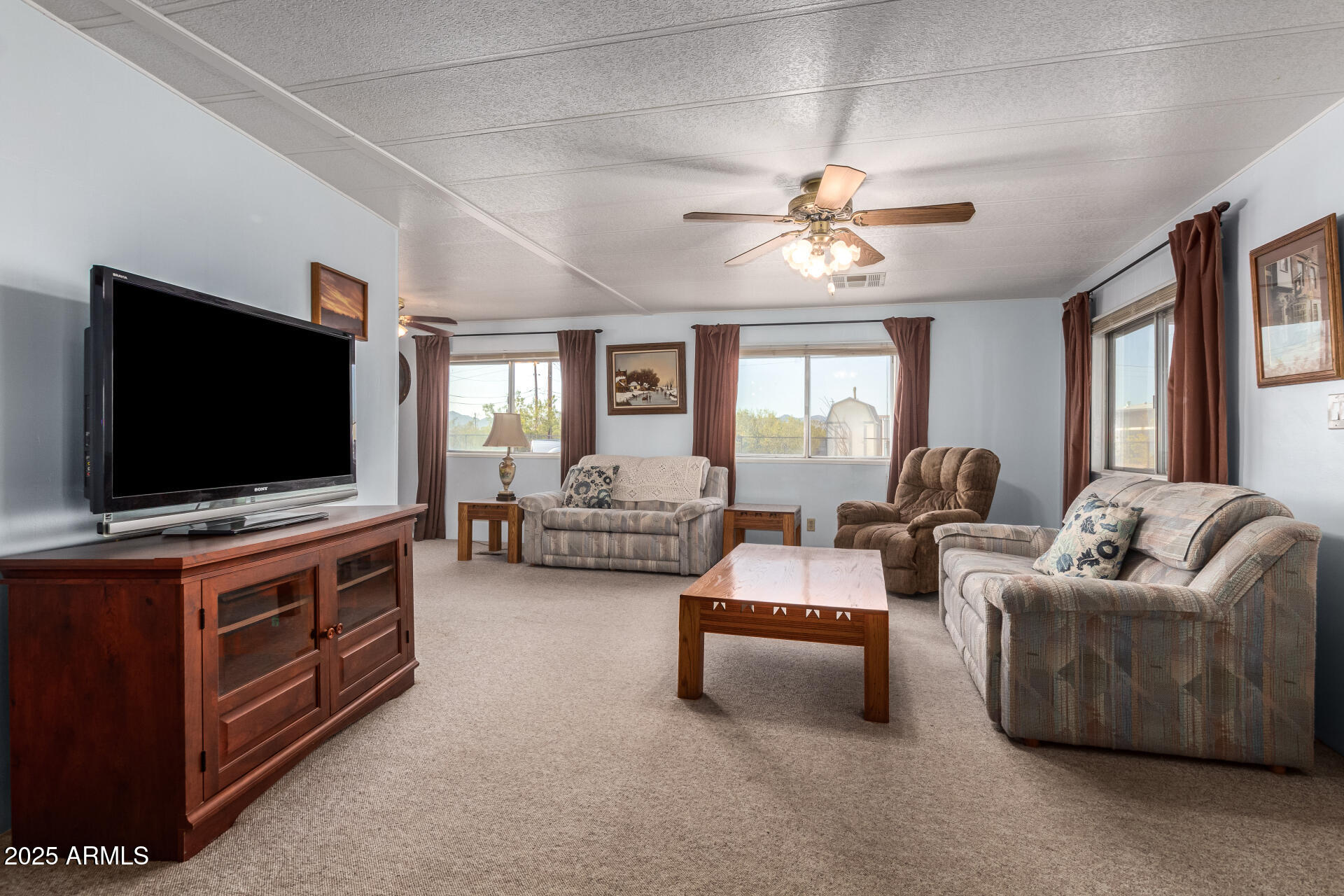 1888 South Goldfield Road Apache Junction, AZ 85119 - Photo 6 of 27 a living room with furniture and a flat screen tv