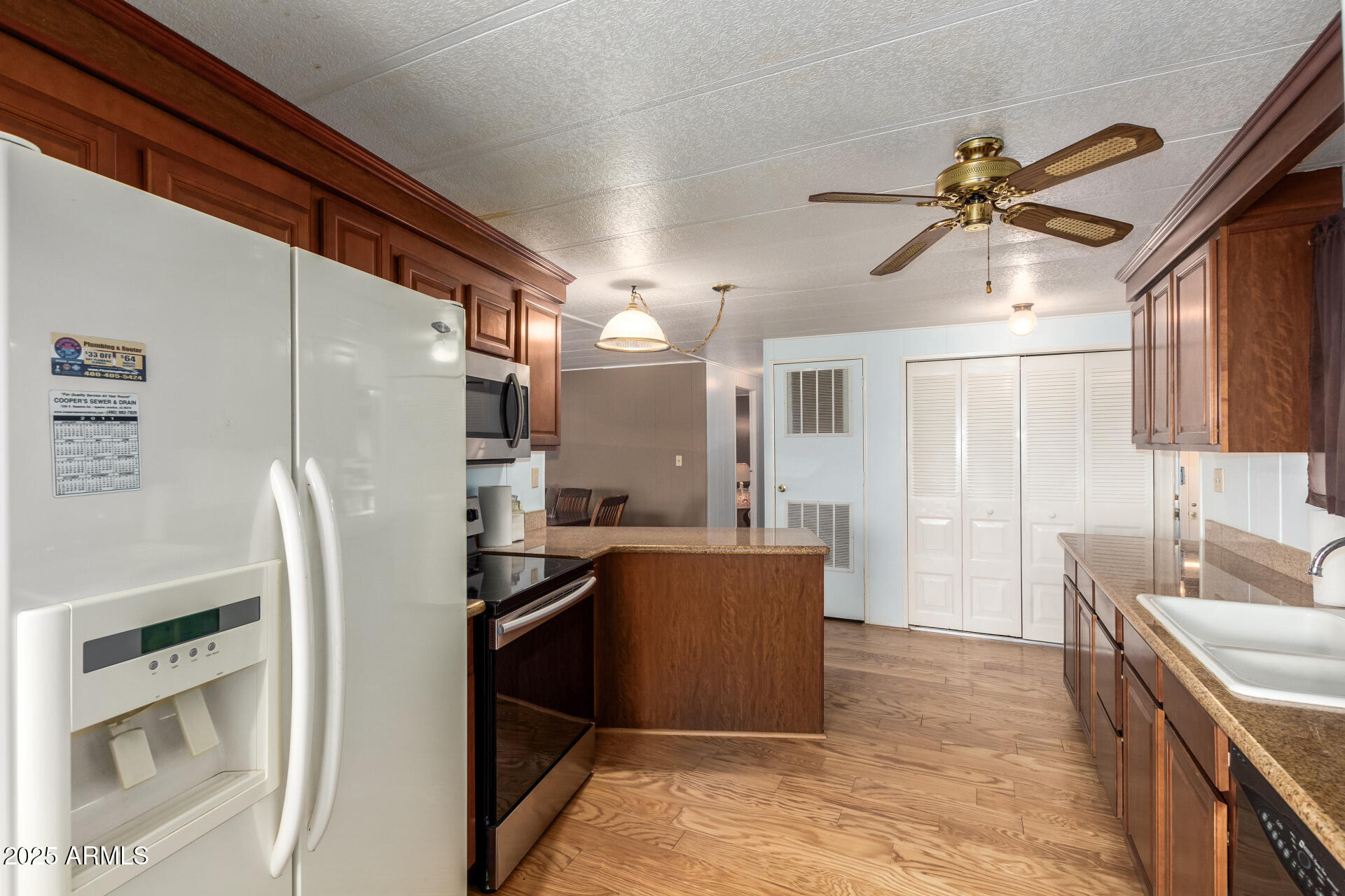 1888 South Goldfield Road Apache Junction, AZ 85119 - Photo 8 of 27 a kitchen with stainless steel appliances a refrigerator sink and stove