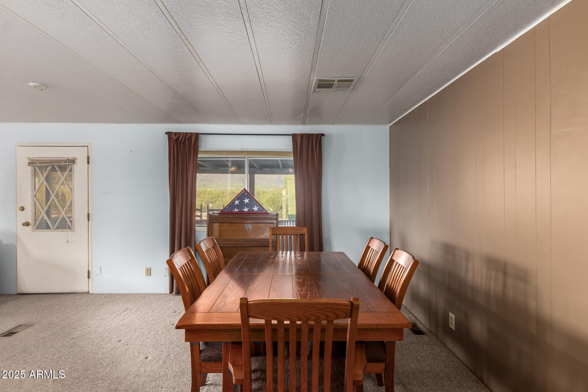 1888 South Goldfield Road Apache Junction, AZ 85119 - Photo 10 of 27 a view of a dining room with furniture window and wooden floor