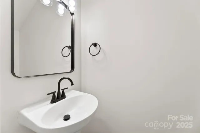 a bathroom with a sink and mirror