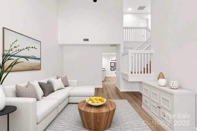 a living room with furniture and a painting on the wall