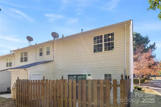 a front view of a house with wooden fence