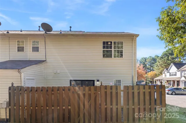 a front view of a house with wooden fence