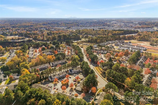 an aerial view of residential houses with city view