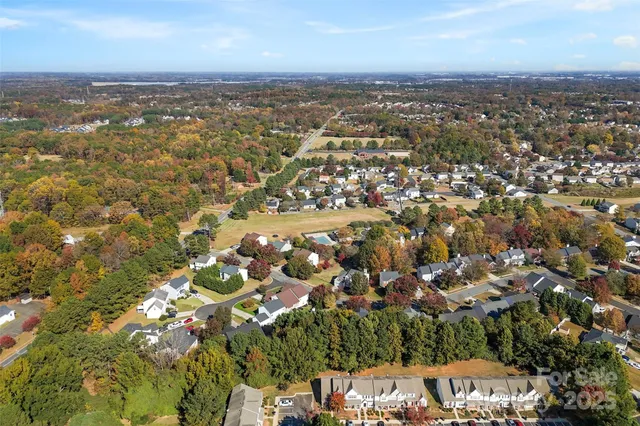 an aerial view of residential houses with city view