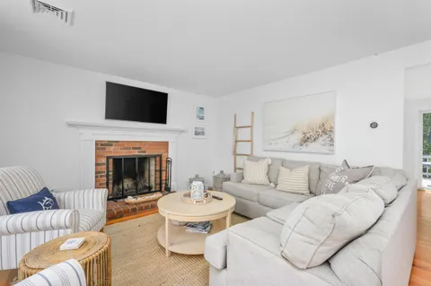 a living room with furniture fireplace and flat screen tv