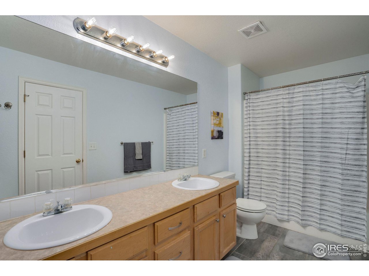 93 Summit View Road Severance, CO 80550 - Photo 10 of 27 a bathroom with a toilet a sink and mirror