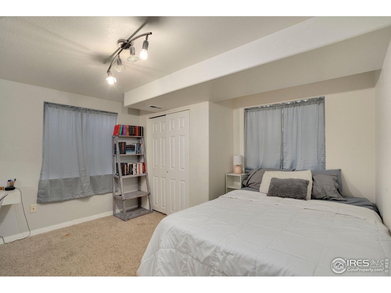 93 Summit View Road Severance, CO 80550 - Photo 16 of 27 a bedroom with a large bed and a chandelier