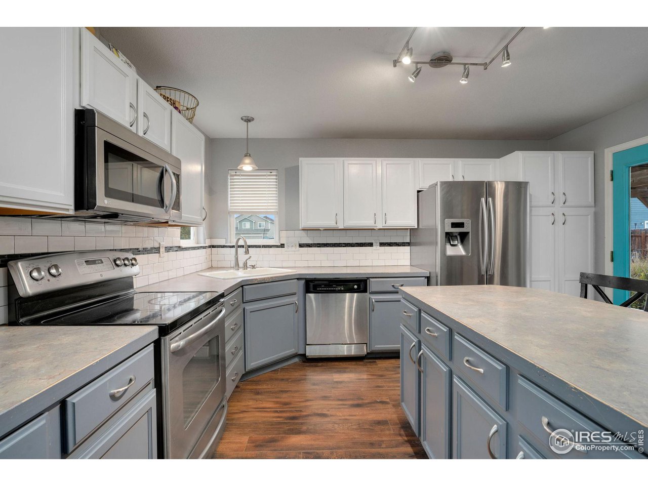 93 Summit View Road Severance, CO 80550 - Photo 8 of 27 a kitchen with stainless steel appliances granite countertop a sink a stove a refrigerator and cabinets