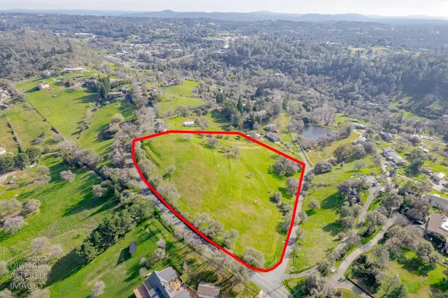 an aerial view of a swimming pool and mountain