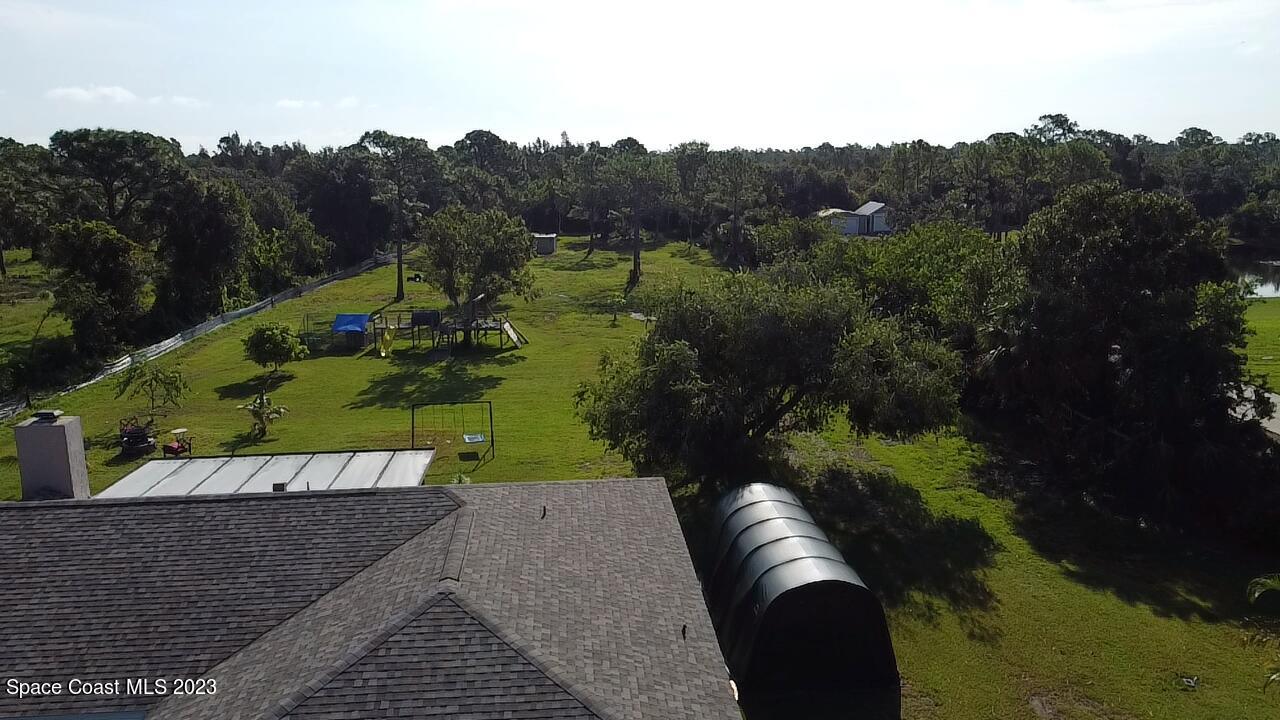 2745 Corey Road Malabar, FL 32950 - Photo 34 of 39 a view of a yard with table and chairs
