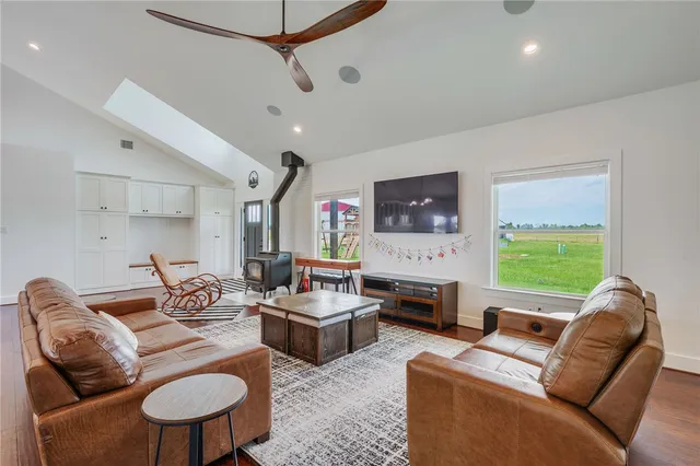 a living room with furniture fireplace and a window