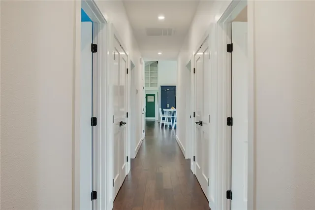 a view of a hallway with a wooden door