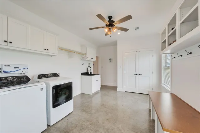 a view of kitchen with sink and wooden cabinet