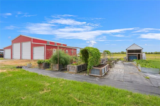 a backyard of a house with table and chairs