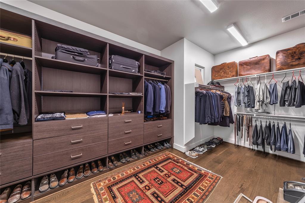 4144 Entrada Way Dallas, TX 75219 - Photo 19 of 34 a view of walk in closet with clothes and shoes