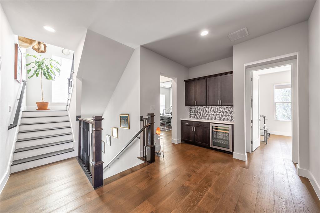 4144 Entrada Way Dallas, TX 75219 - Photo 25 of 34 a view of a livingroom with wooden floor and staircase