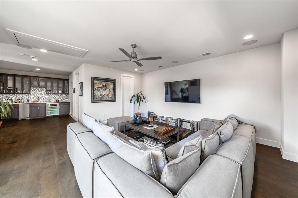 4144 Entrada Way Dallas, TX 75219 - Photo 30 of 34 a living room with furniture and a wooden floor