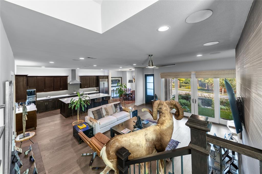 4144 Entrada Way Dallas, TX 75219 - Photo 6 of 34 a living room with furniture a flat screen tv and floor to ceiling window