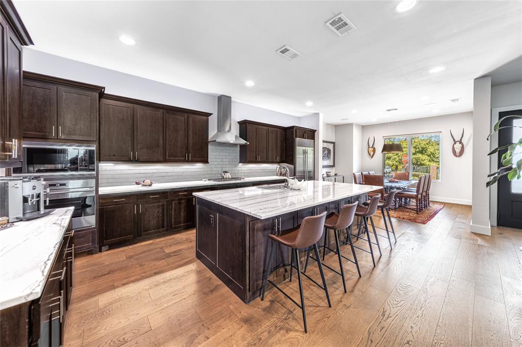 4144 Entrada Way Dallas, TX 75219 - Photo 9 of 34 a kitchen with a sink a counter top space appliances and cabinets