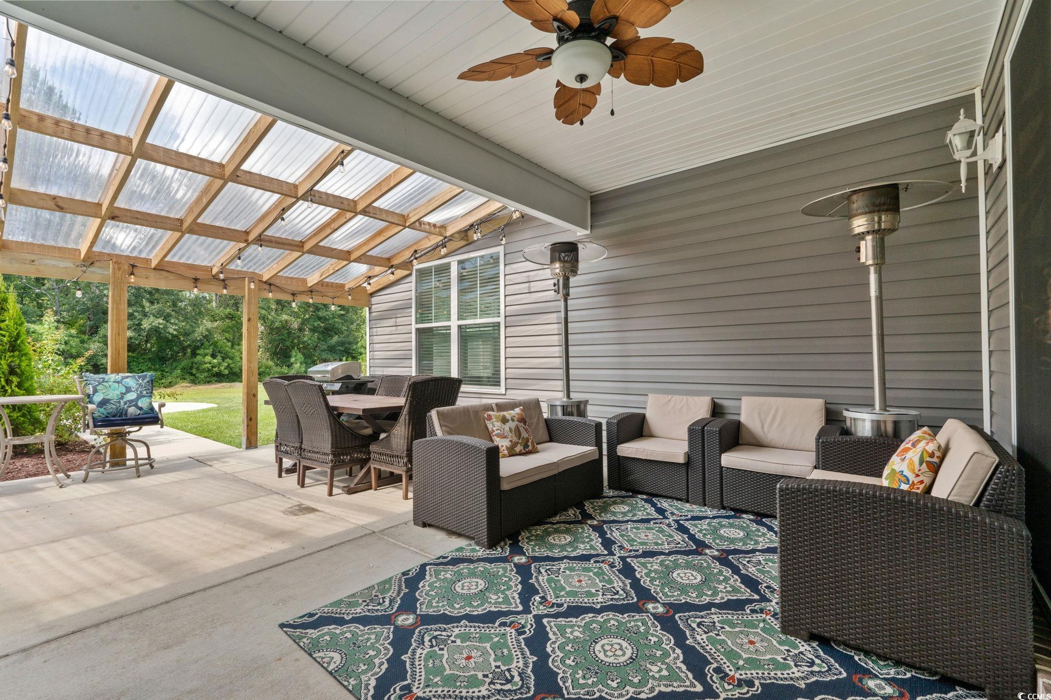 2133 Carries Lane Road Longs, SC 29568 - Photo 13 of 40 View of patio featuring an outdoor living space, outdoor dining area, and ceiling fan