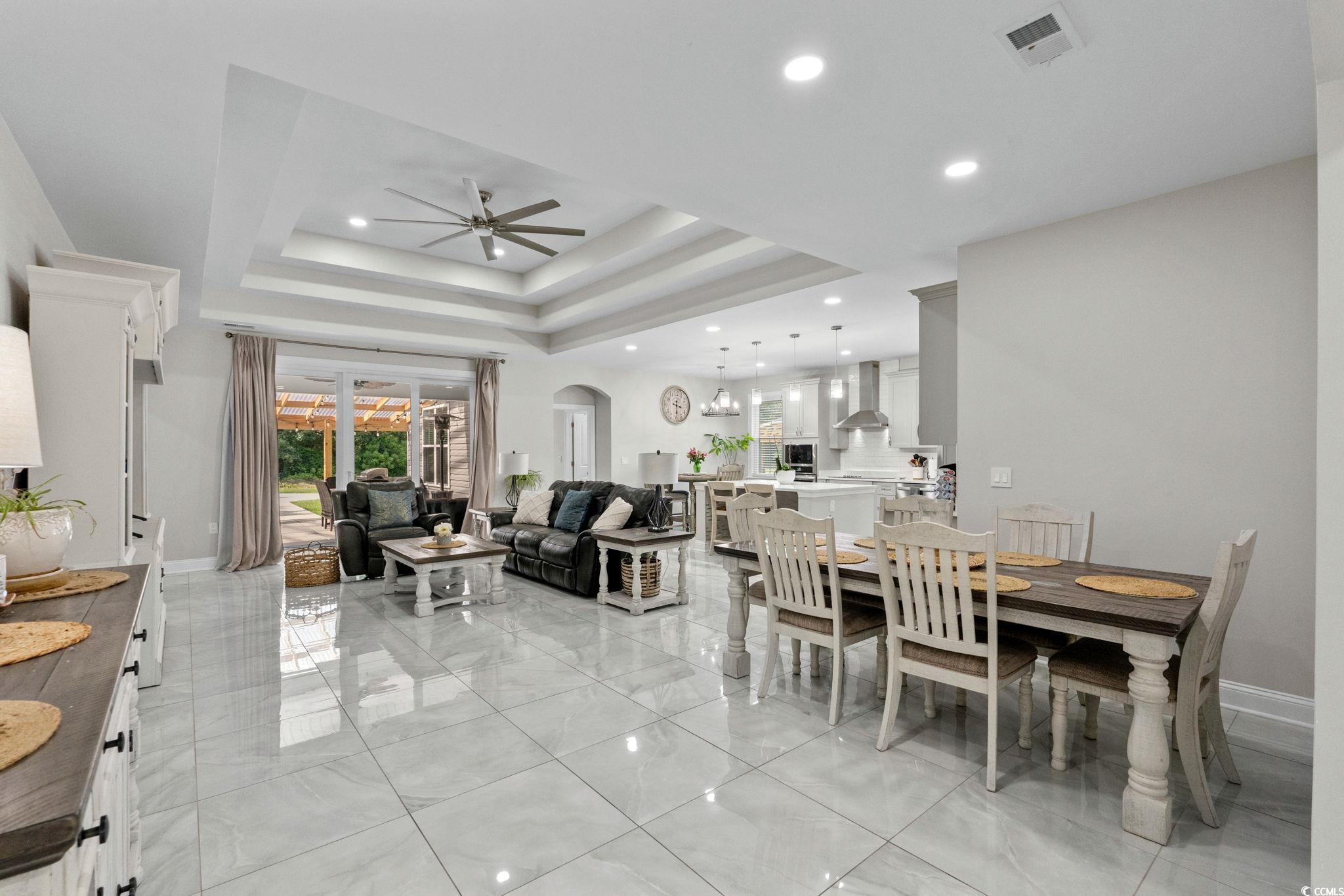 2133 Carries Lane Road Longs, SC 29568 - Photo 3 of 40 Dining space with ceiling fan, recessed lighting, a tray ceiling, arched walkways, and a chandelier