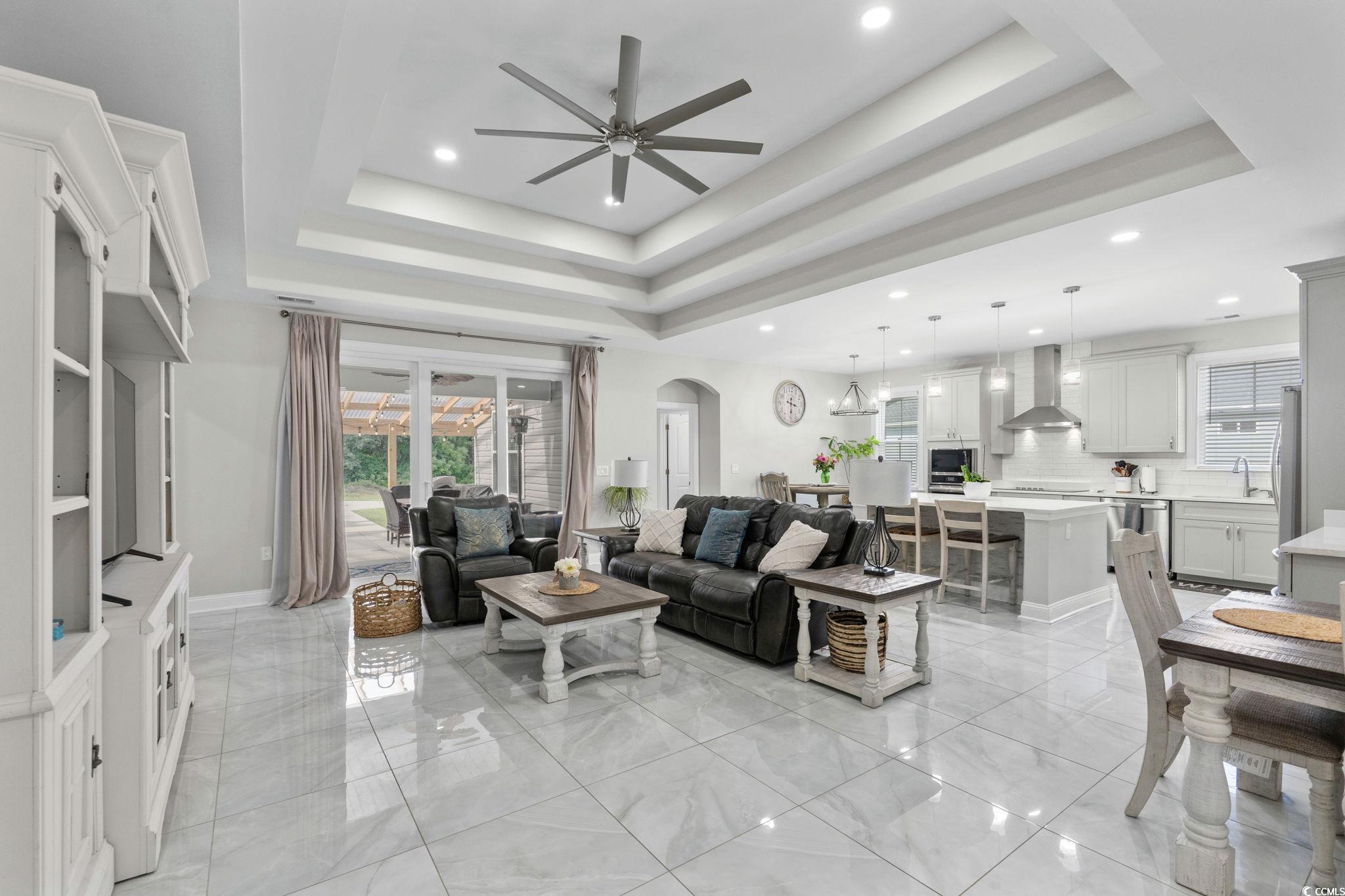 2133 Carries Lane Road Longs, SC 29568 - Photo 4 of 40 Living room with plenty of natural light, recessed lighting, a ceiling fan, arched walkways, and a tray ceiling