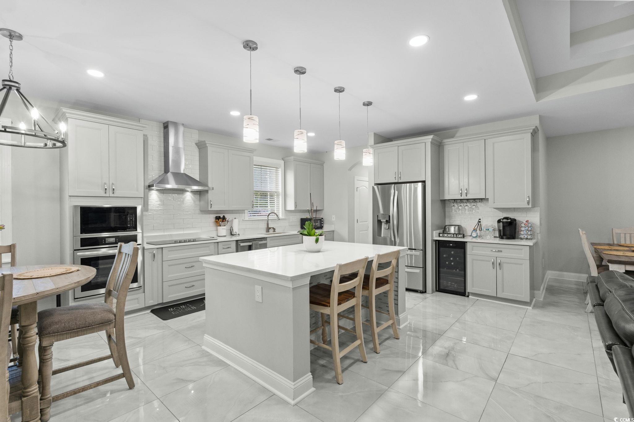 2133 Carries Lane Road Longs, SC 29568 - Photo 8 of 40 Kitchen featuring backsplash, black appliances, light marble finish floors, wall chimney range hood, and recessed lighting